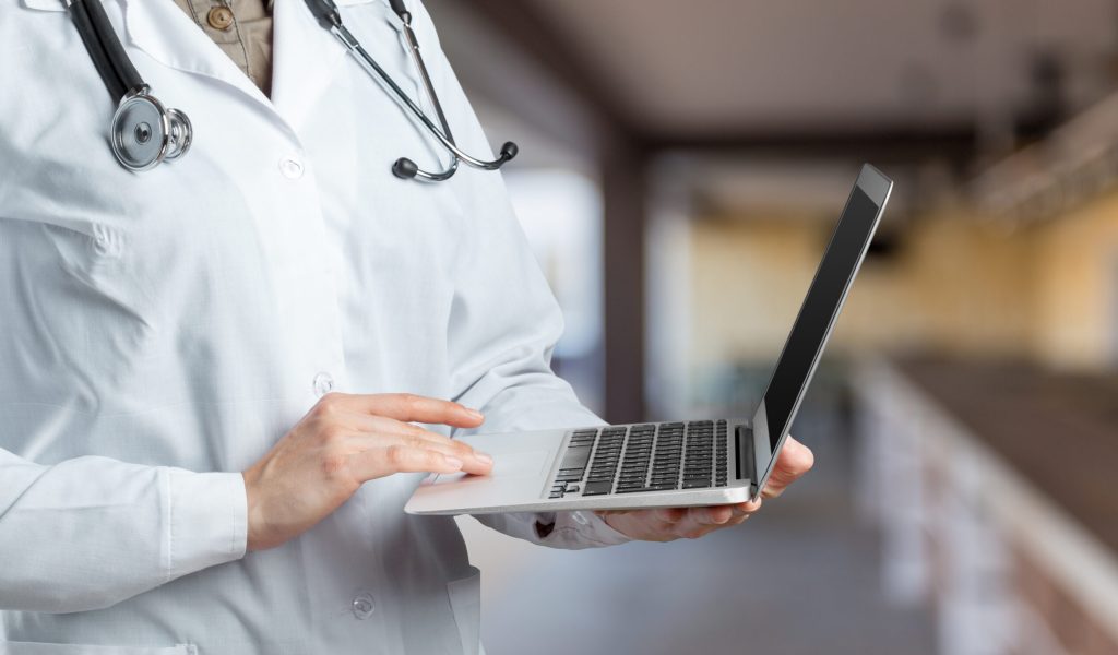 Hands of medical doctor woman with laptop